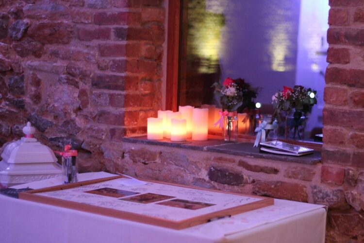 LED Candles behind wedding memory table