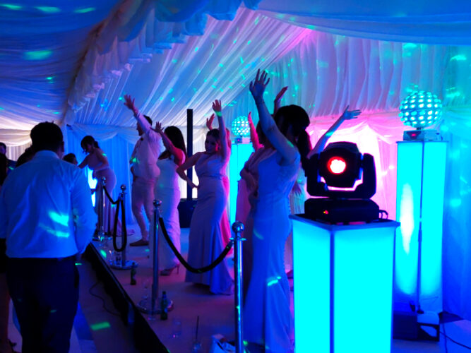Dancing on the stage to our DJ in marquee wedding, Cuffley, Hertfordshire