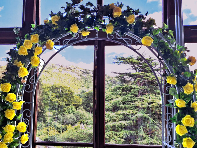 Artificial garlnds and flowers on metal-framed decorative arch