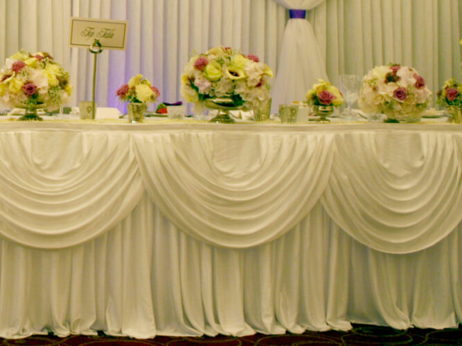 Table skirt decoration for top table at wedding reception