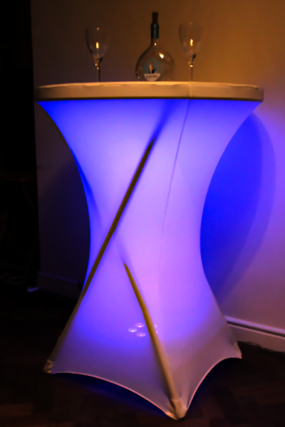 White posear table up-lit in purple