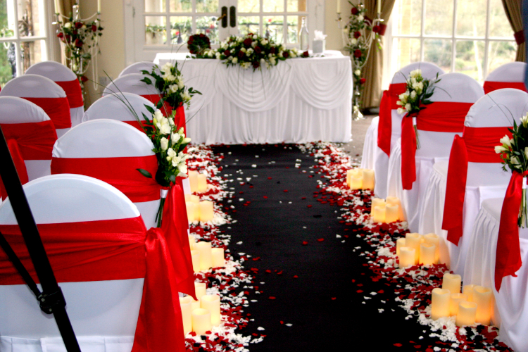 Candles lining the aisle at a wedding in Ponsbourne Park, Hertford